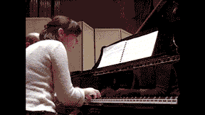 A gif of Des turning pages for the Pianist Nika Shirocorad