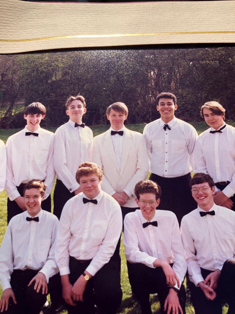 An image of Des with eight other teenage boys, all dressed in Black Tie, it is a picture of their choir. 