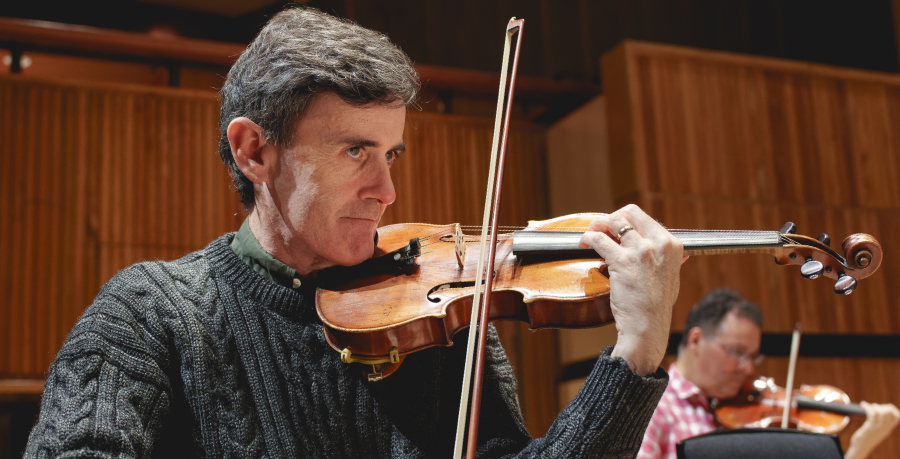 RPO player Anthony Protheroe playing his violin in rehearsal.