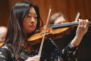 RPO Player Esther Kim playing the violin in rehearsal