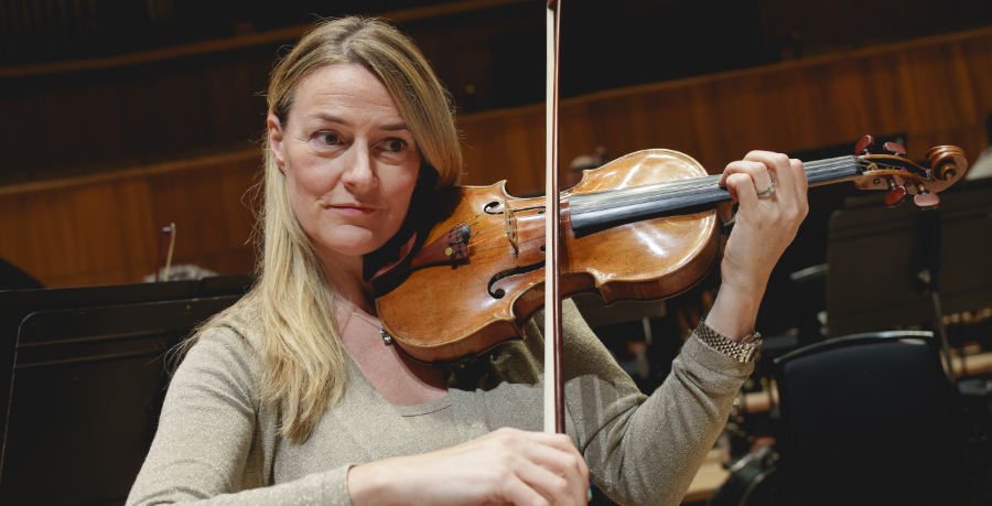 RPO Player Jennifer Christie playing the violin in rehearsal.