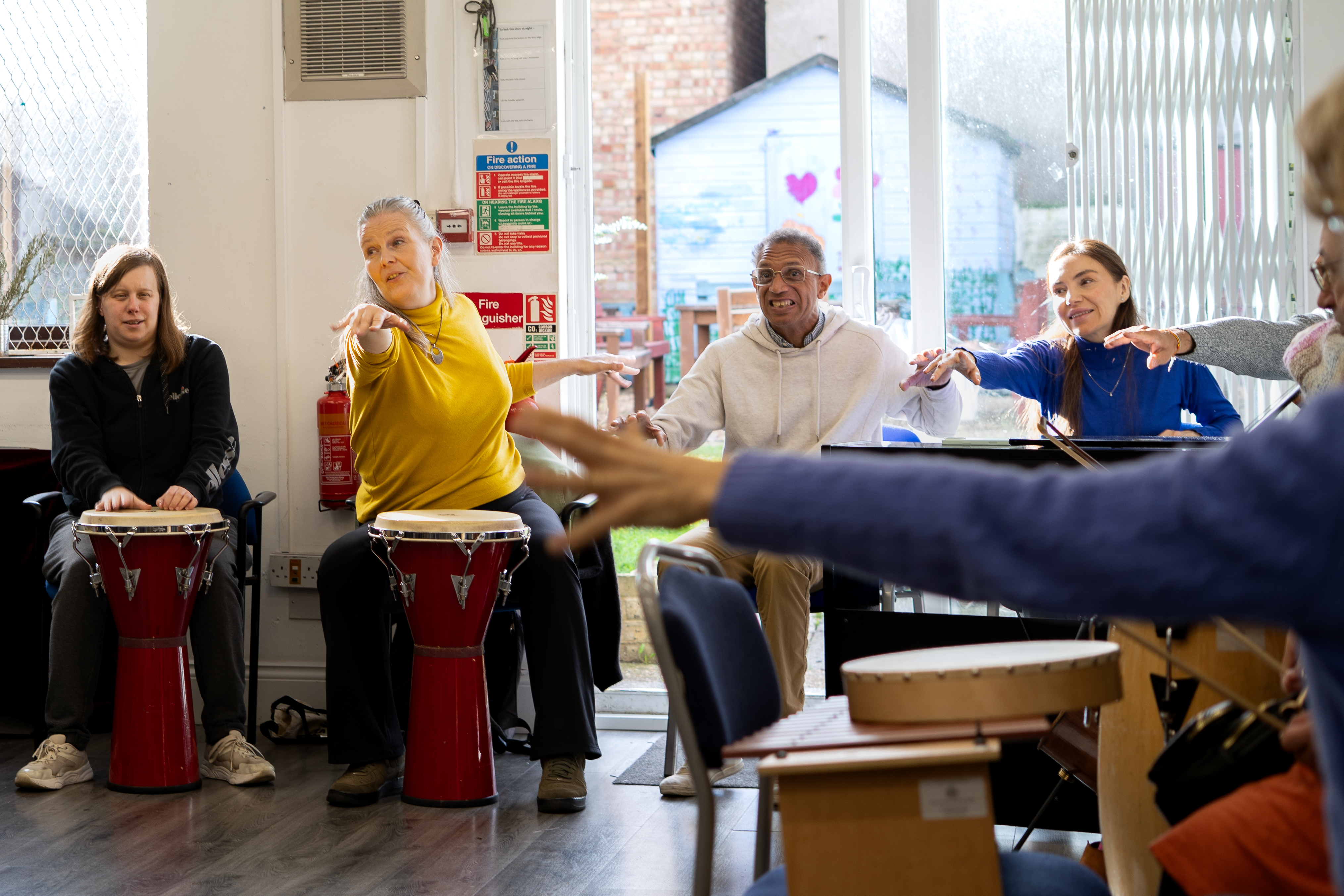 Participants reaching arms into group circle