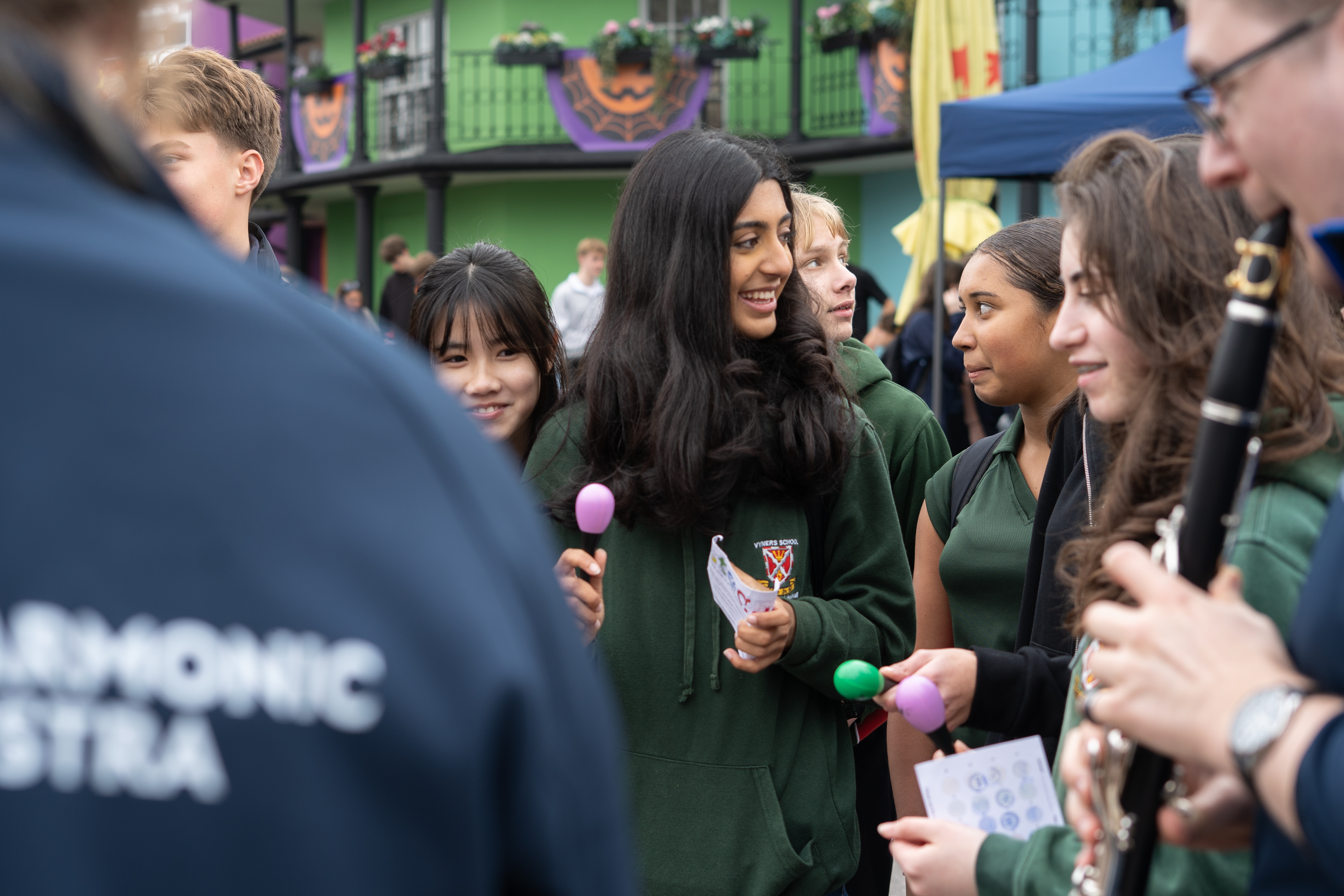 Participants holding maracas and jamming with RPO musicians