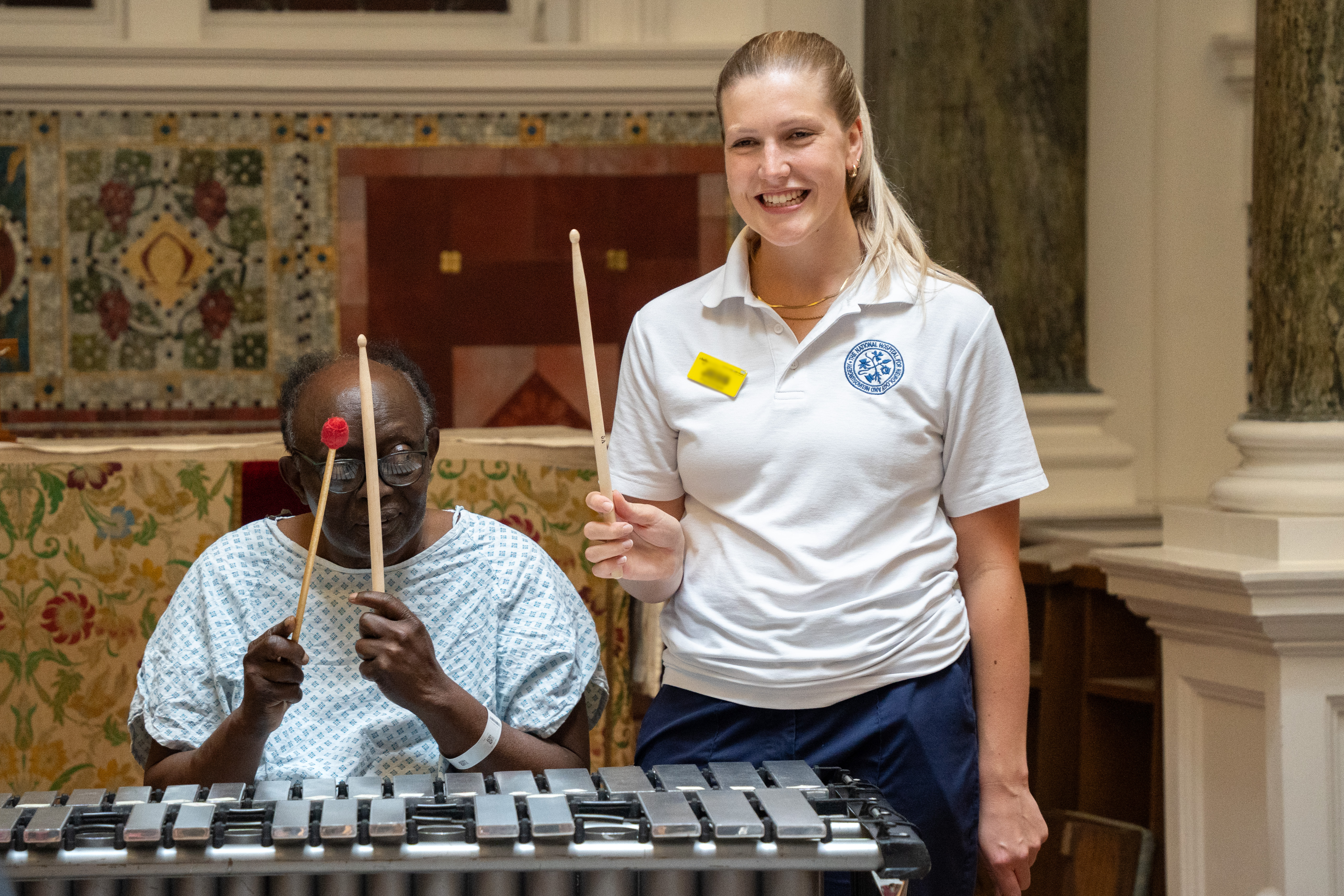 Participant and clinician holding drumsticks