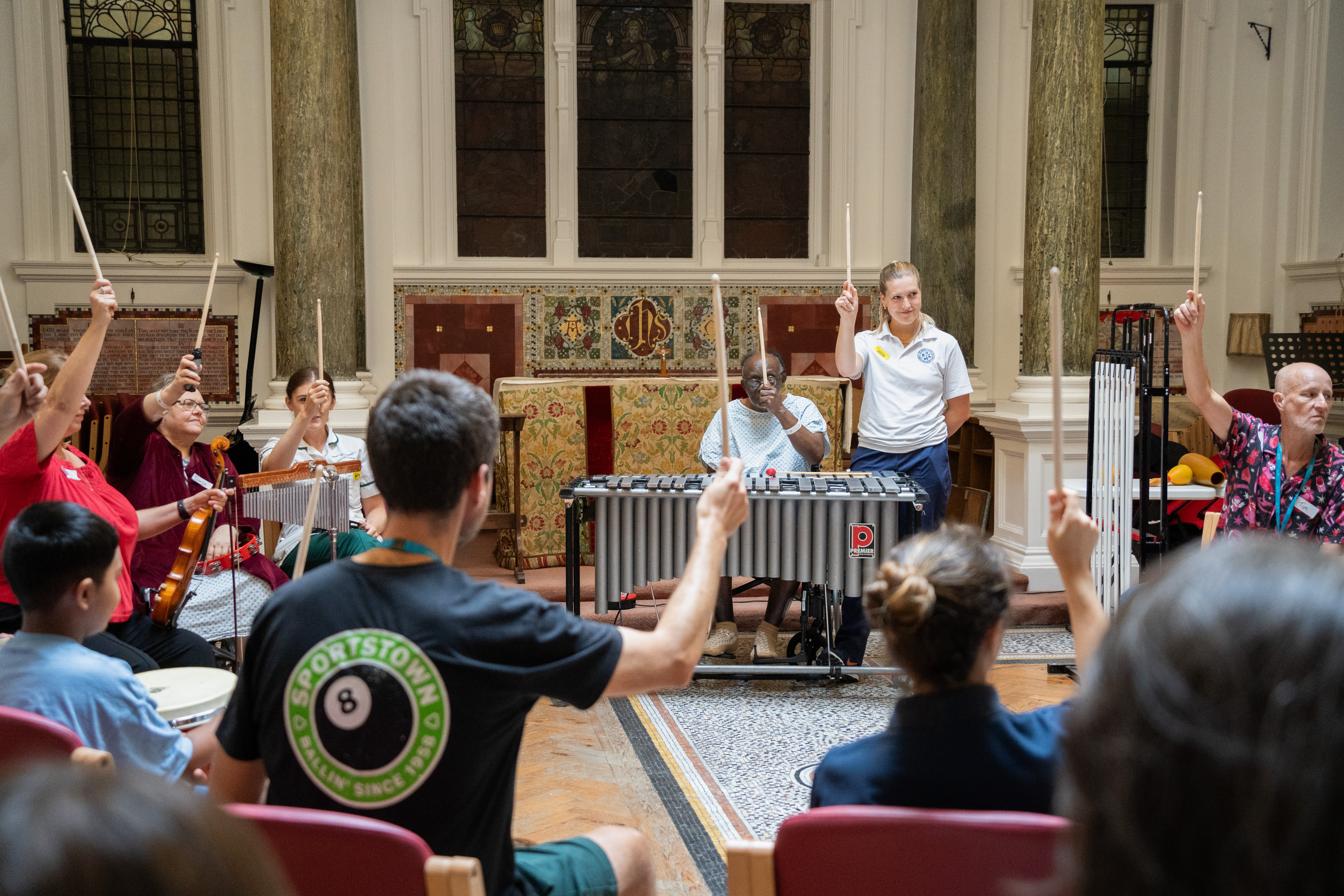 Final performance, shows group holding drumsticks