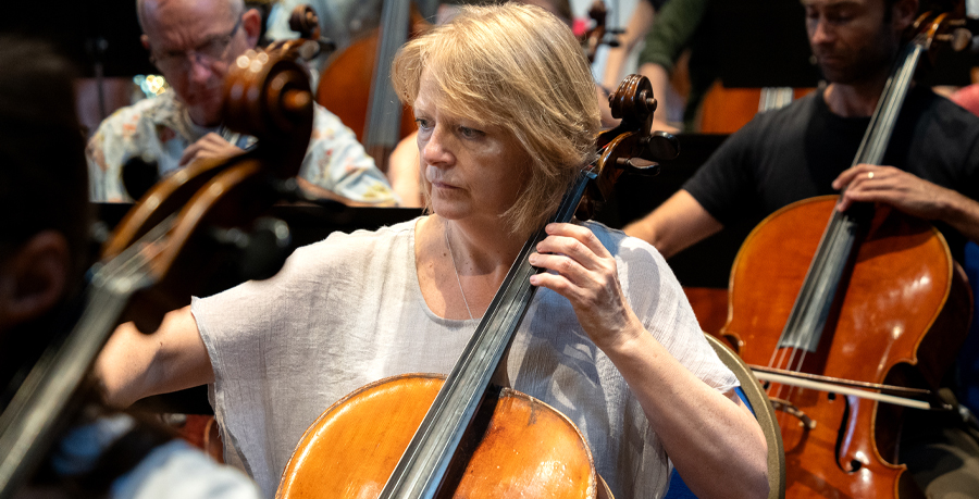 Chantal playing the cello in rehearsal