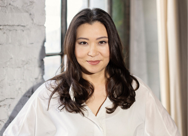 Portrait of Shiyeon Sung standing in front of a window
