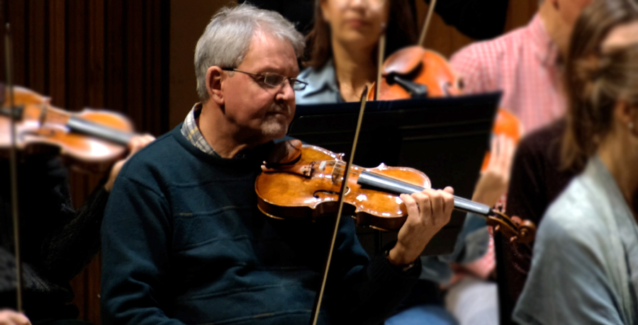 RPO player Andrew Klee playing violin in rehearsal.