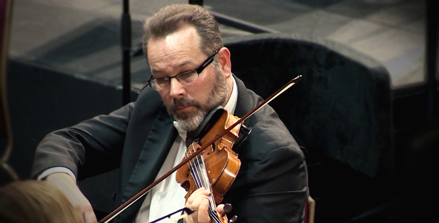 RPO Player Charles Nolan playing the violin in concert.