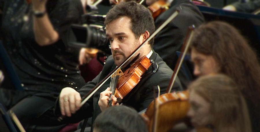 RPO player Joseph Fisher playing the viola on the concert stage.