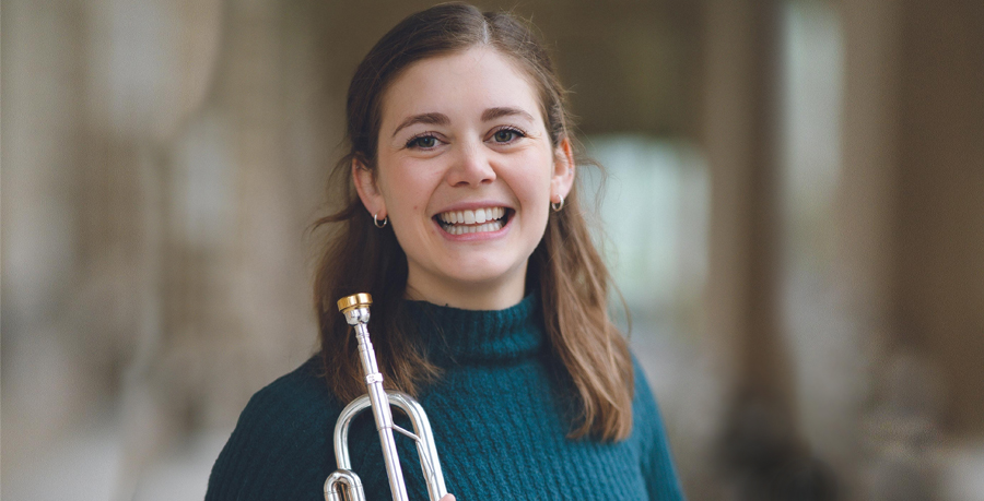 Kaitlin Wild smiling and holding her trumpet