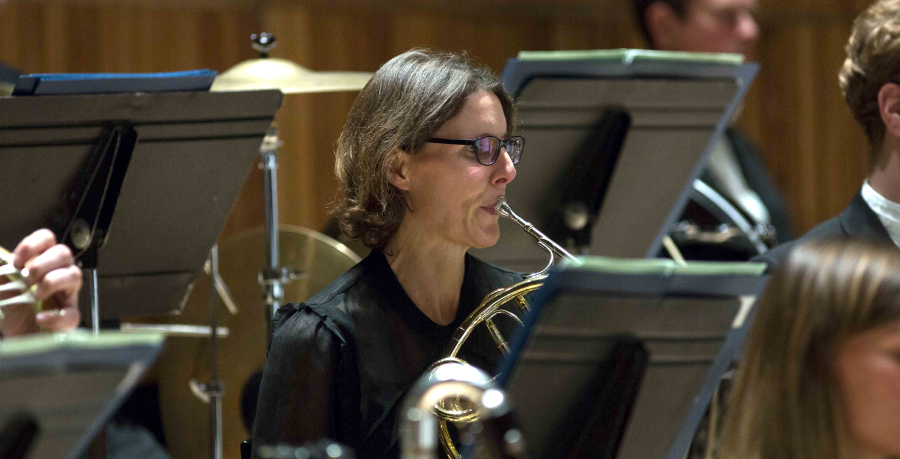 RPO Player Kathryn Saunders playing the horn in concert.