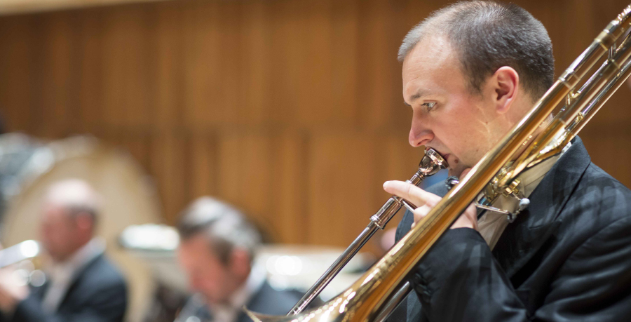 RPO Player Matthew Gee playing the trombone in concert.
