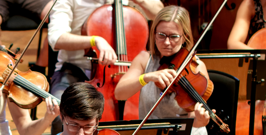 Pamela playing the viola in rehearsal.