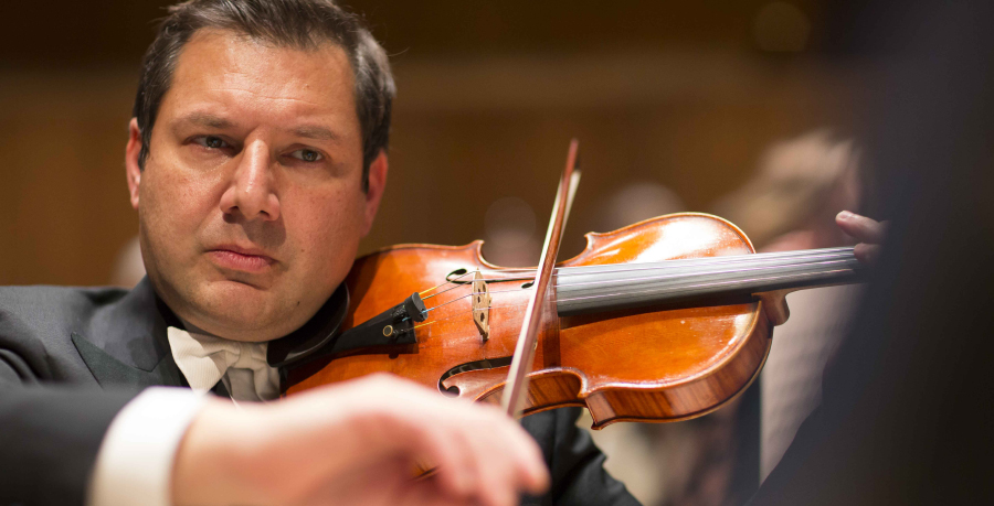 RPO Player Peter Graham playing the violin in concert.