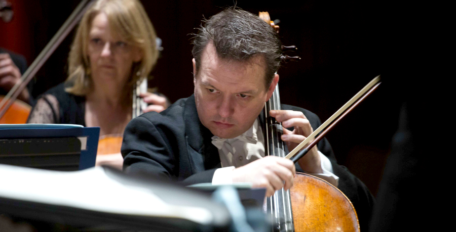 RPO player Richard Harwood playing the cello in concert.