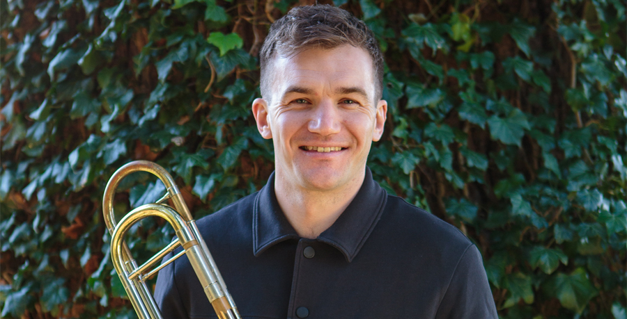 Tom Berry smiling and holding his trombone