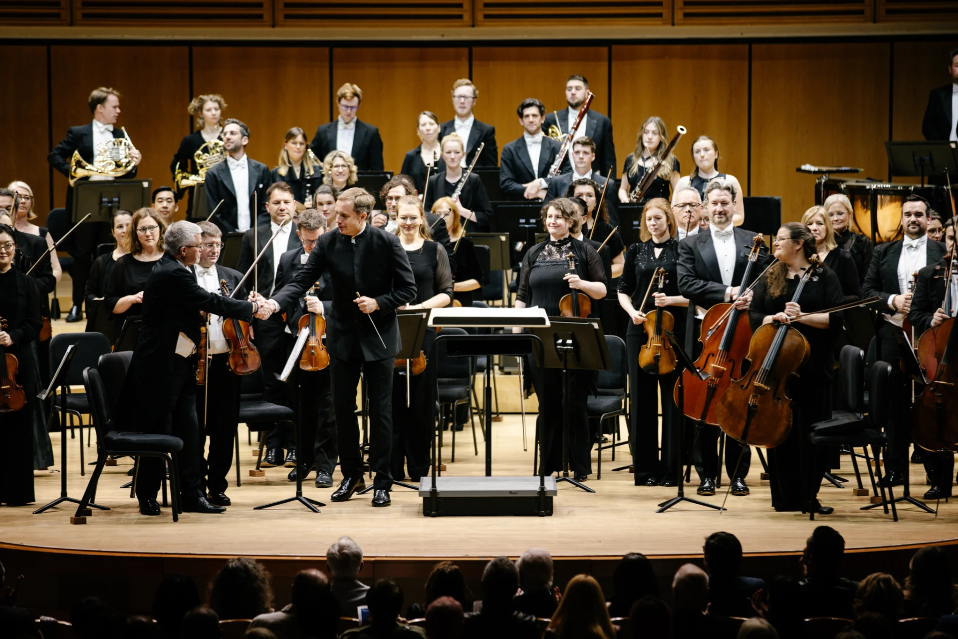 Vasily Petrenko shaking hands with leader Duncan Riddell at the end of an RPO concert at the Miami Arsht Center.