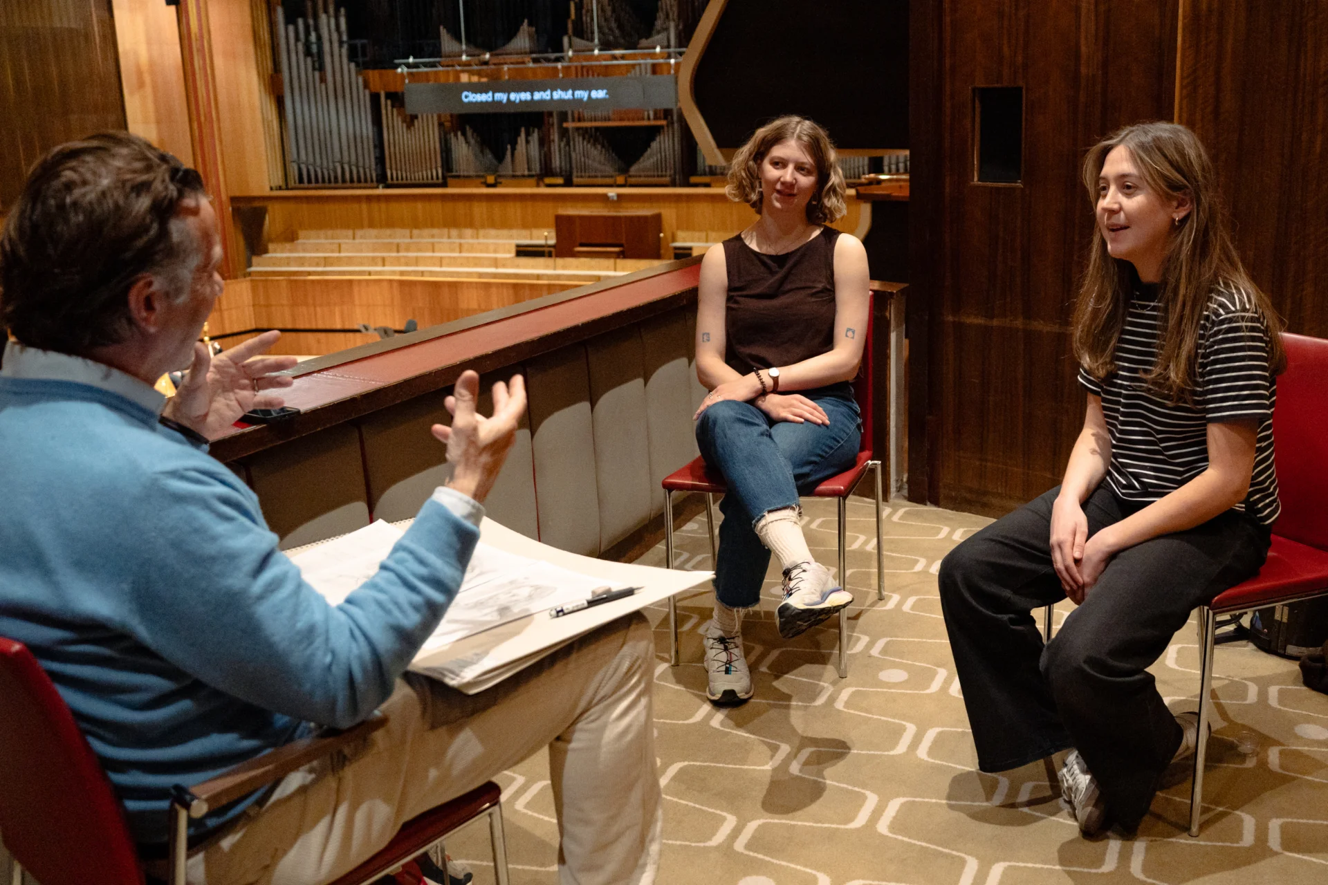 Jeremy Houghton sketching and chatting with two RPO players in a box at the Royal Festival Hall