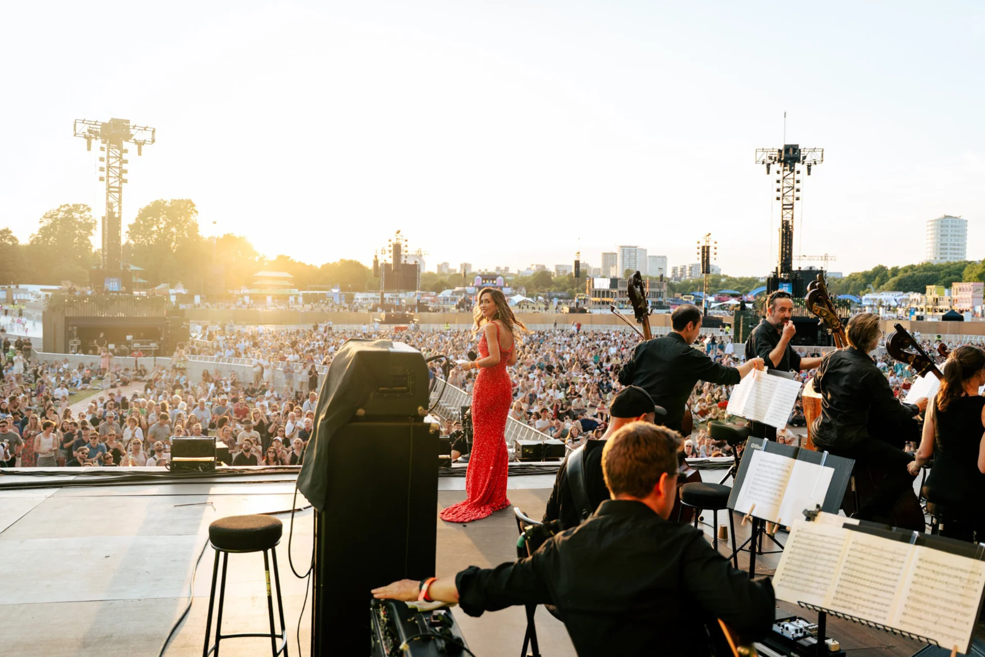 Myleene Klass in a red dress on stage with the Orchestra at BST Hyde Park