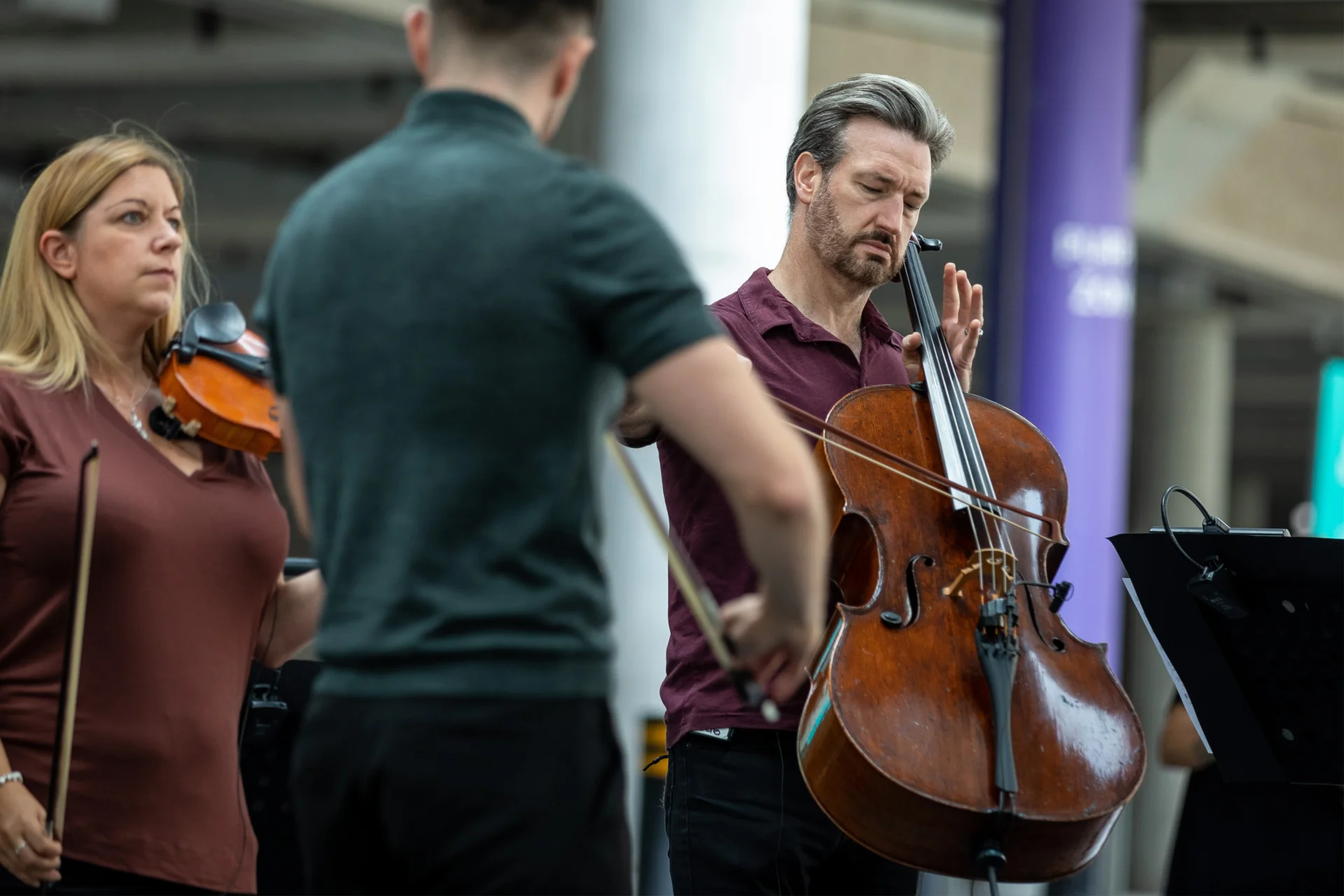 RPO string players performing underneath the steps by Wembley Stadium