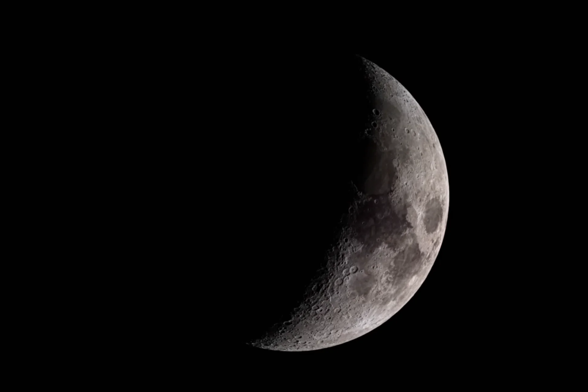 The moon half covered in shadow.