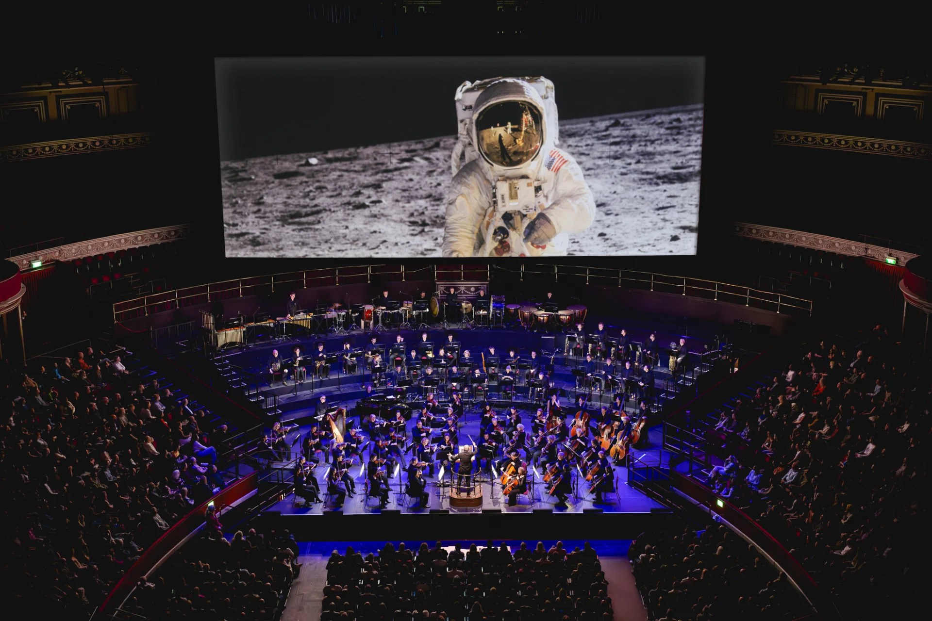 The Royal Albert Hall in concert with a screen showing Justin Sutcliffe's image of astronaut on the moon.