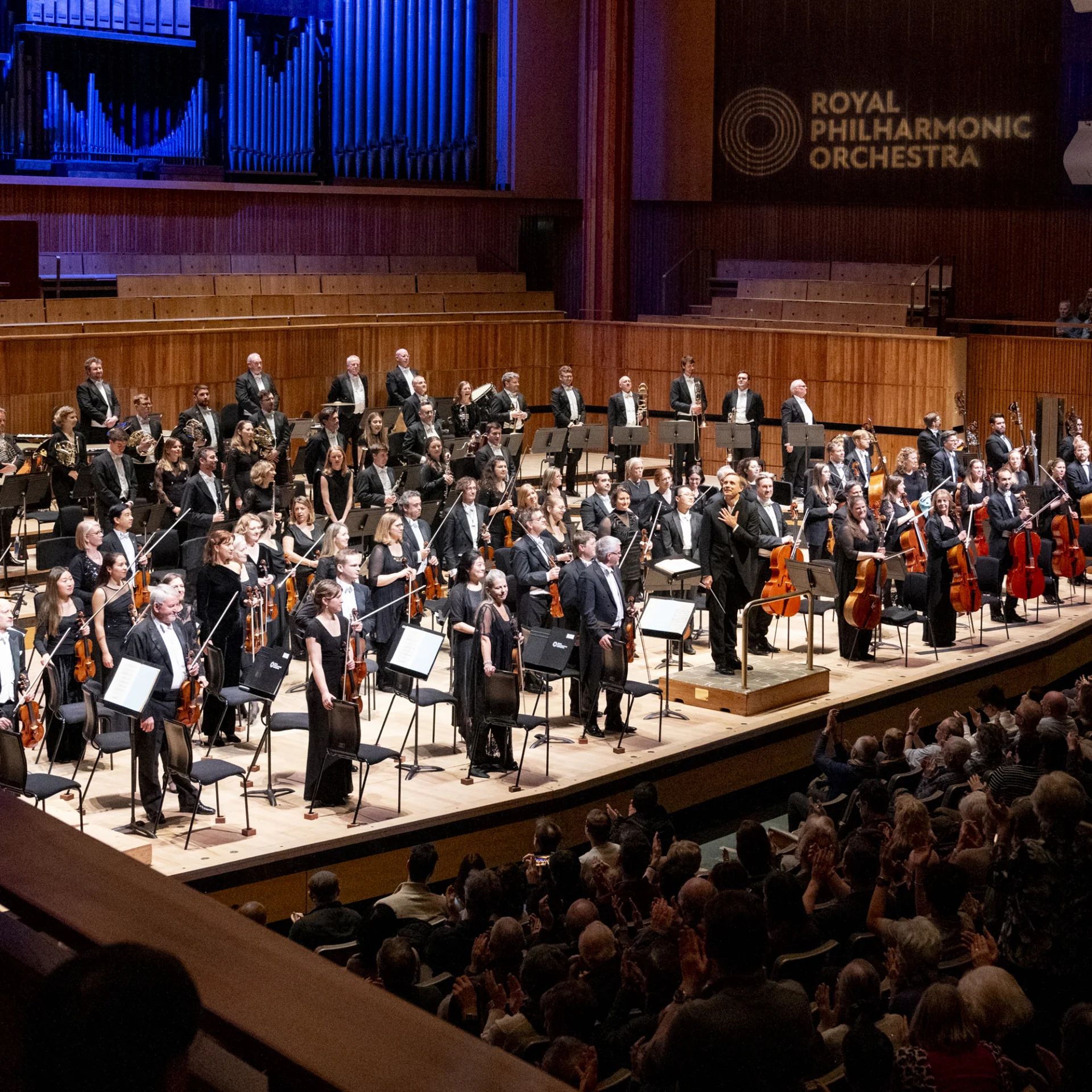 The RPP and Vasily Petrenko standing on stage to receive applause at the Royal Festival Hall