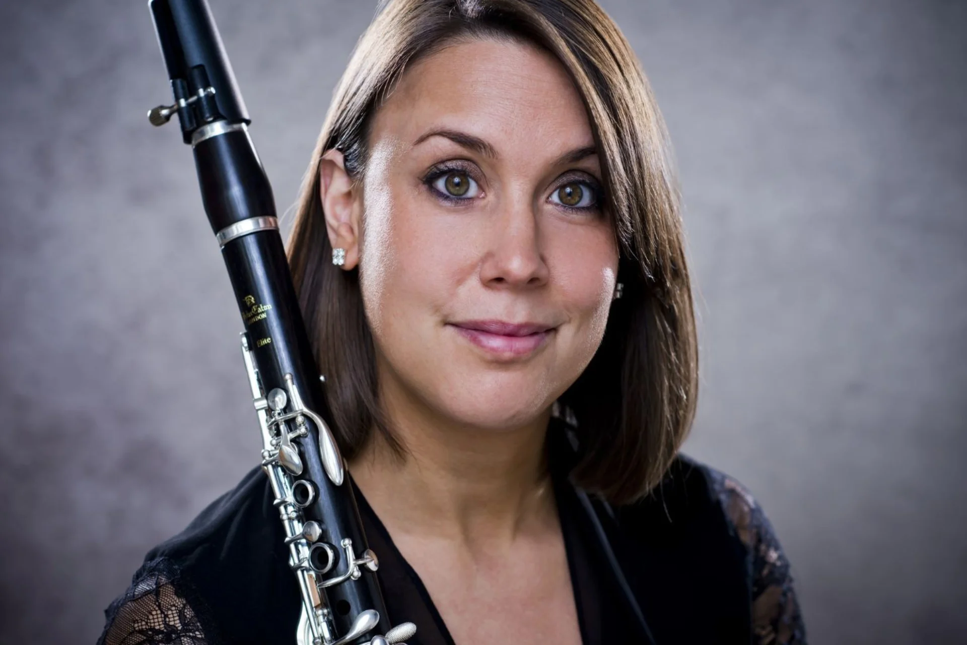 Close up of Katherine Lacy, holding her clarinet across her shoulder