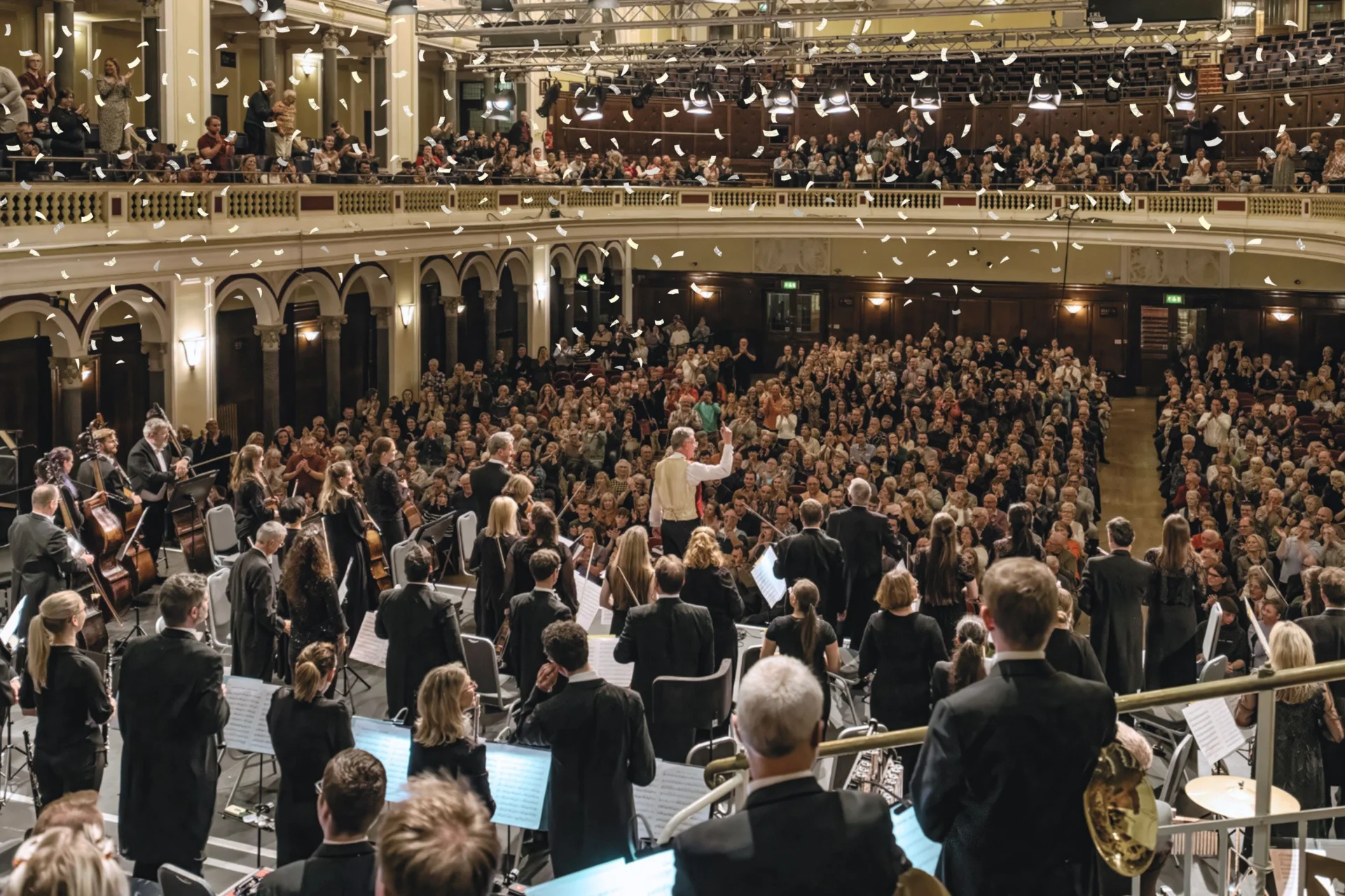 The Royal Philharmonic Orchestra performs for a packed Hull City Hall, with festive confetti falling from the ceiling