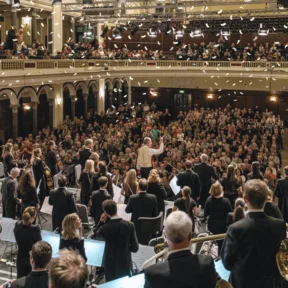 The Royal Philharmonic Orchestra performs for a packed Hull City Hall, with festive confetti falling from the ceiling