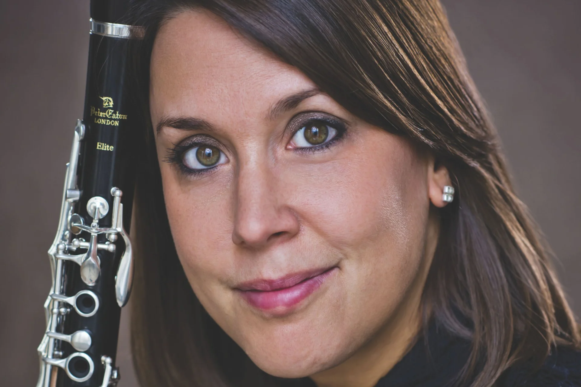 Close up headshot of Katherine Lacy and her Clarinet