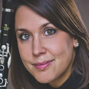Close up headshot of Katherine Lacy and her Clarinet