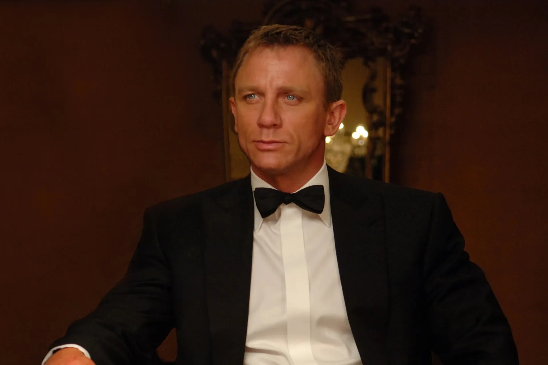 James Bond seated in a tuxedo