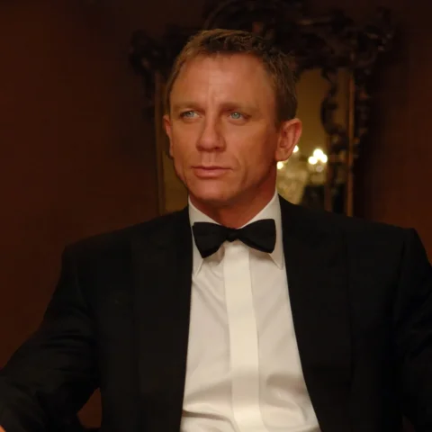 James Bond seated in a tuxedo