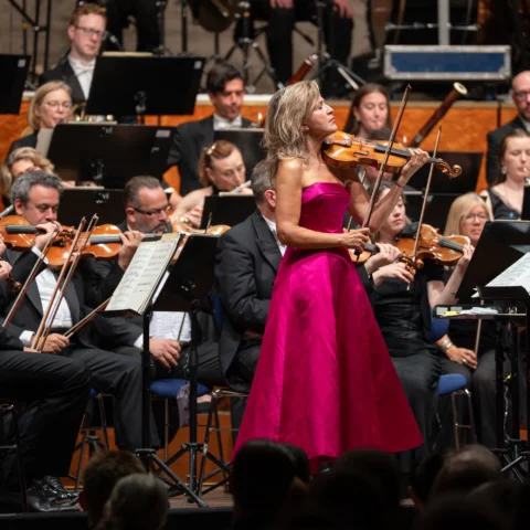 Anne-Sophie Mutter performing on stage with the Orchestra