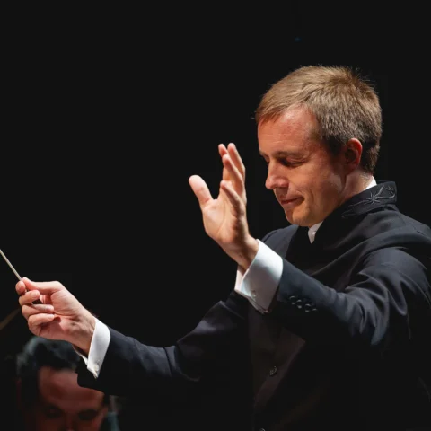 Vasily Petrenko conducting with his eyes closed and arms raised
