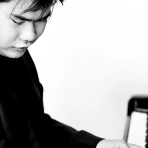 A black and white photo of Nobuyuki Tsujii playing the piano