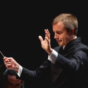 Vasily Petrenko conducting with his eyes closed and arms raised