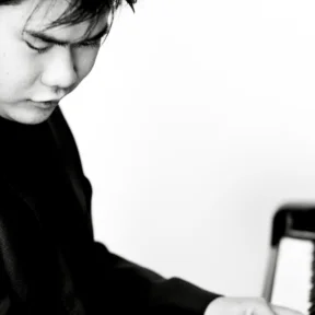 A black and white photo of Nobuyuki Tsujii playing the piano