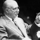 A historical black and white photo of Thomas Beecham conducting