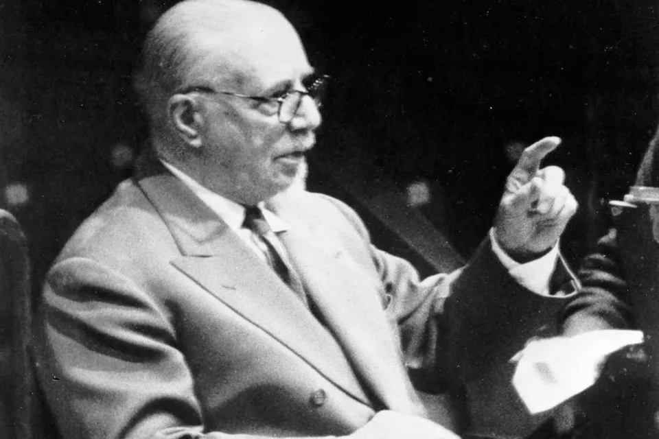 A historical black and white photo of Thomas Beecham conducting