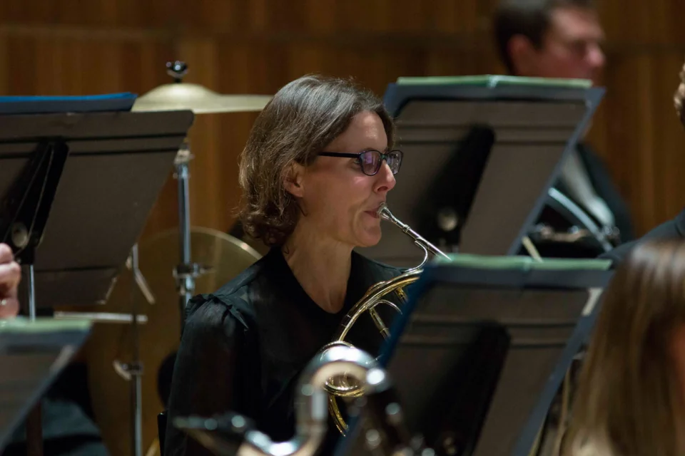 Kathryn Saunders playing horn in black top