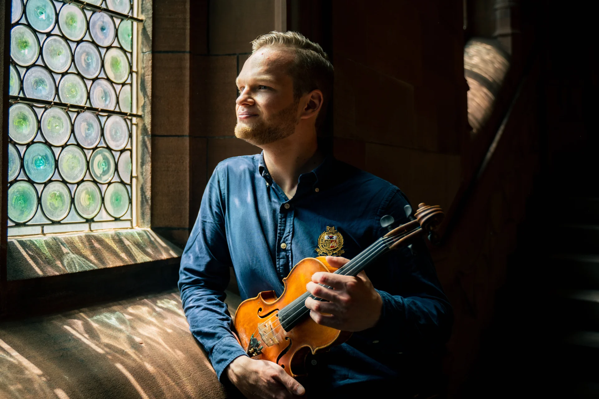 Savva Zverev gazing out the window with his violin