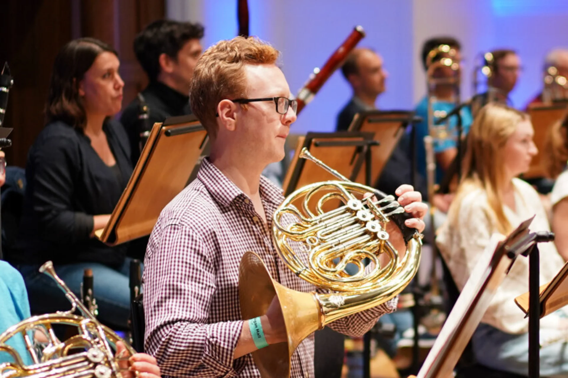 Alexander Edmundson sitting in Orchestra with horn