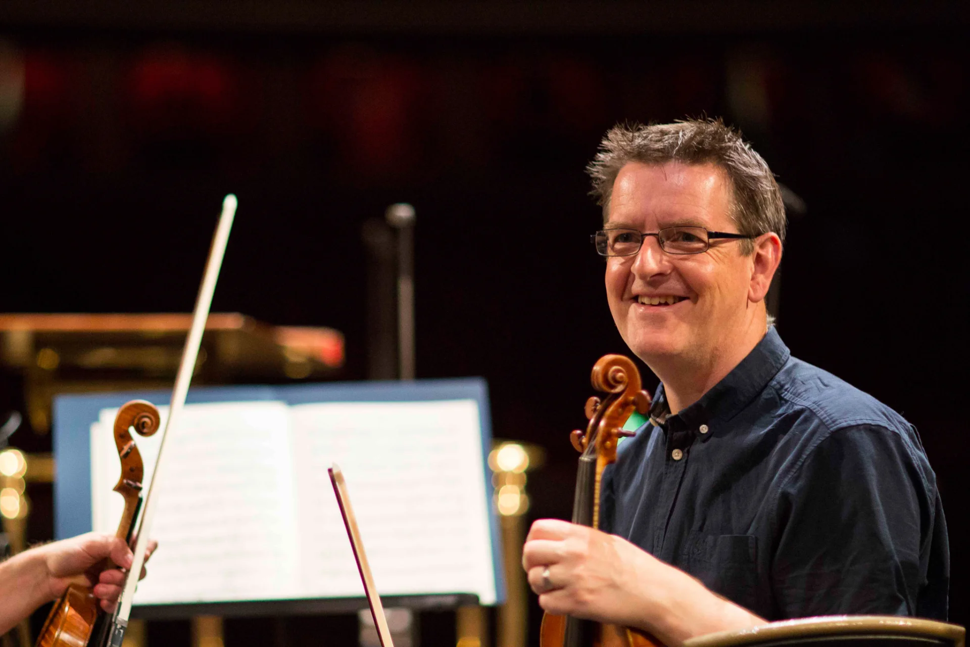 Andrew Storey smiling with violin