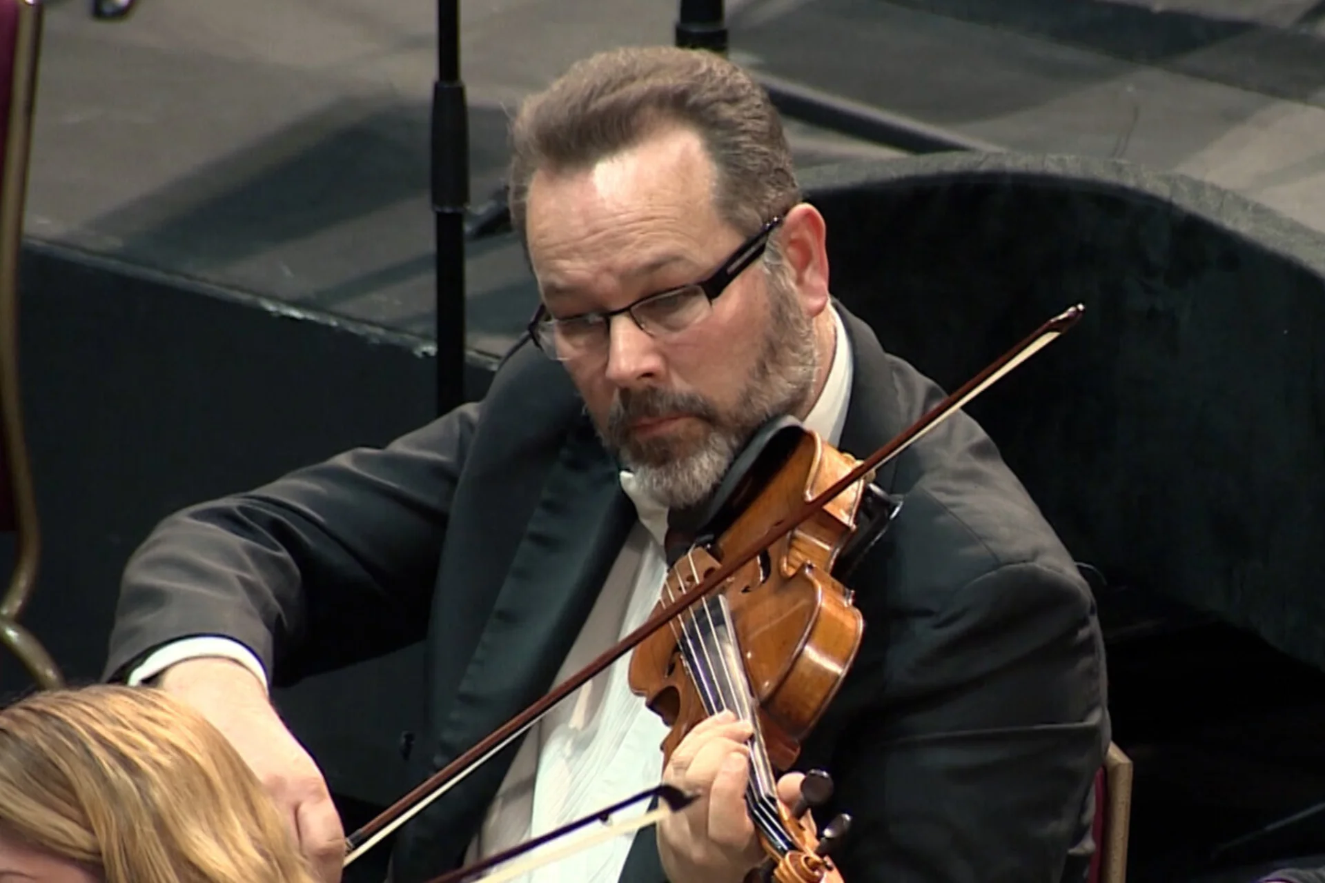 Charles Nolan playing the violin sitting down