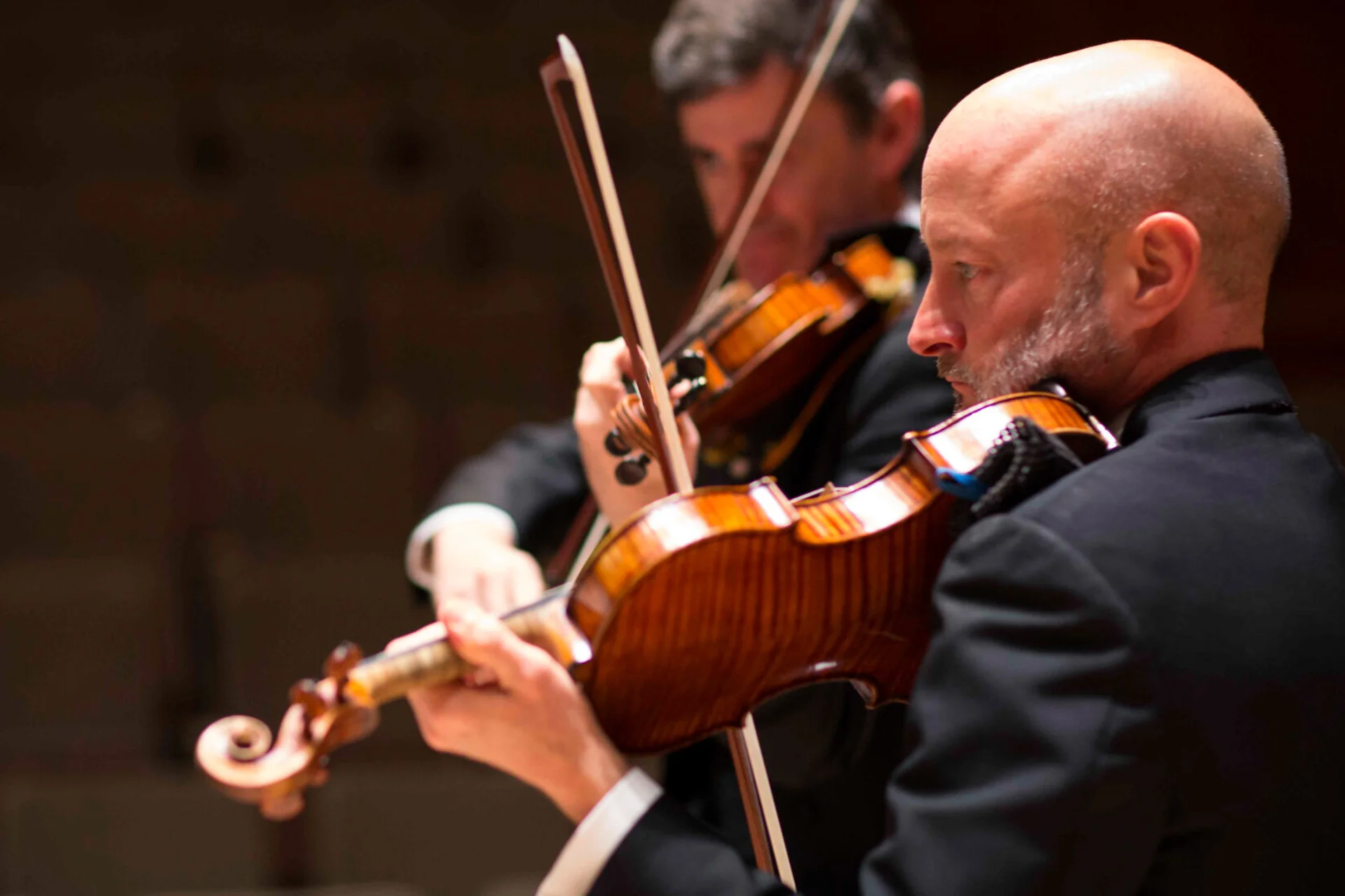 Erik Chapman playing the violin in the Orchestra