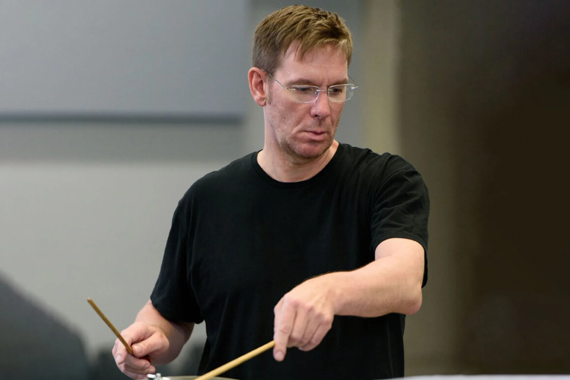 Martin Owens playing cymbal in a black top