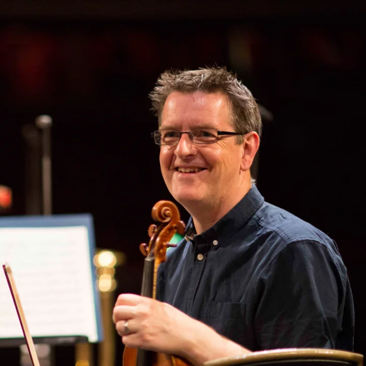 Andrew Storey smiling with violin